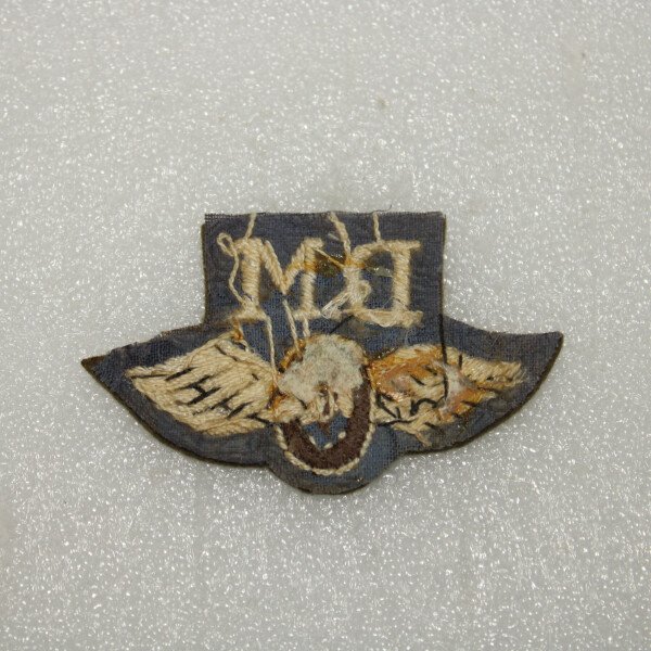 Badge D.M